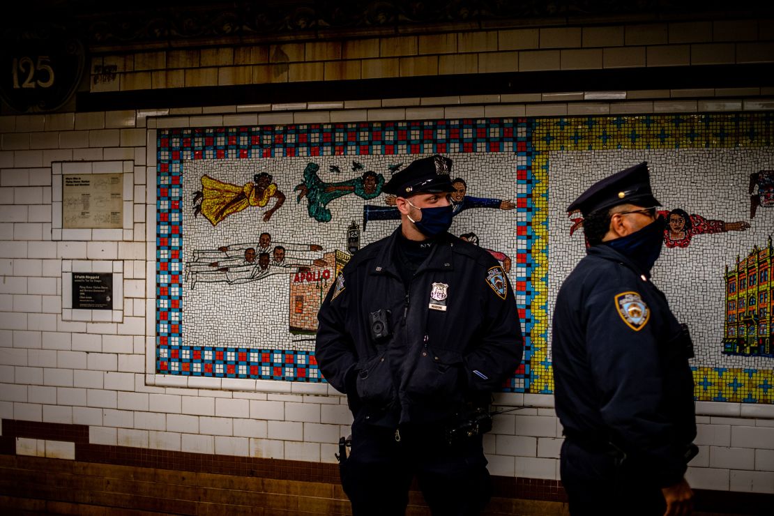 Police officers standing inside the Harlem 125 Street Station.