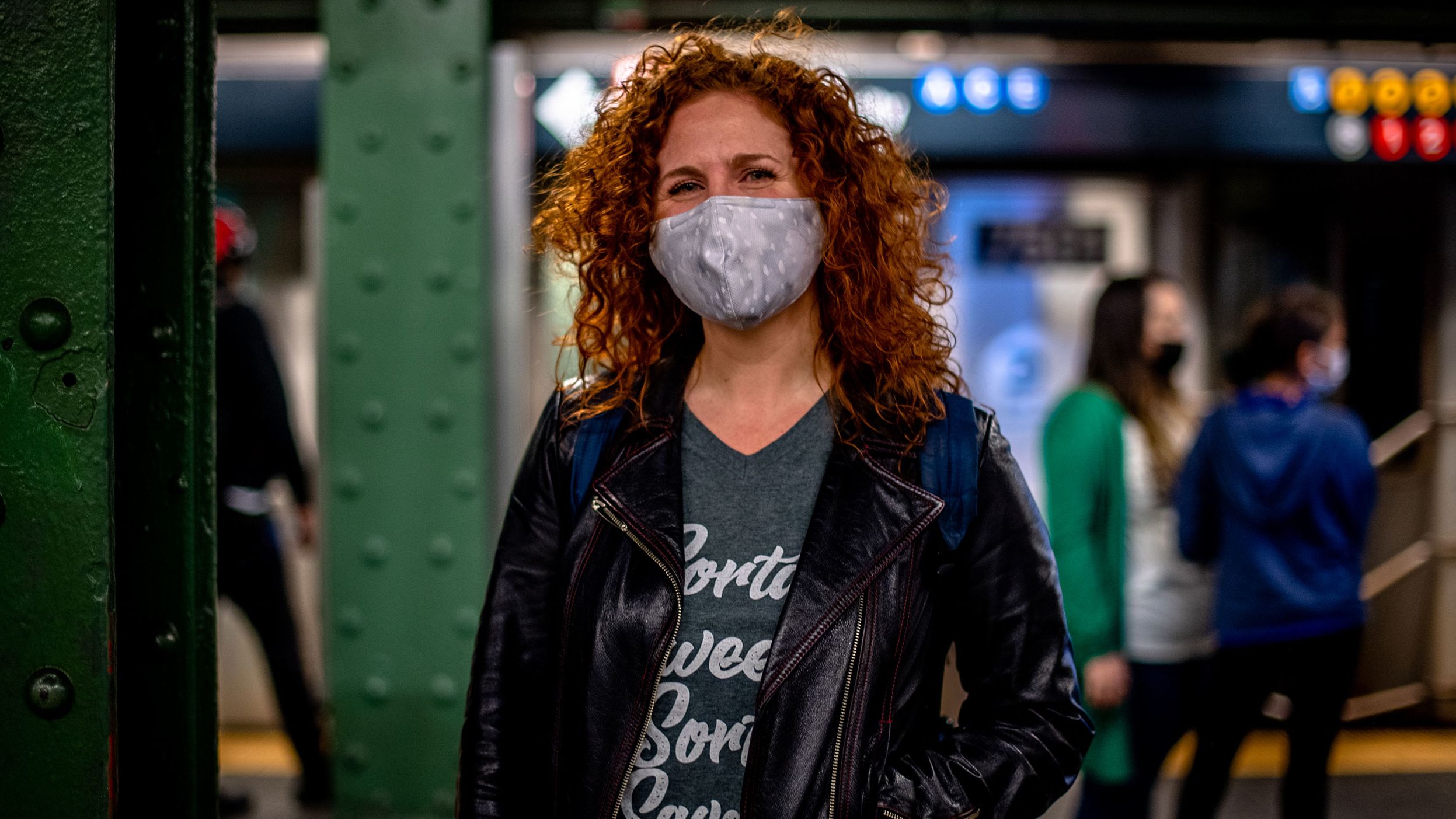 Dana Aber stands at a Times Square-42 Street subway platform.