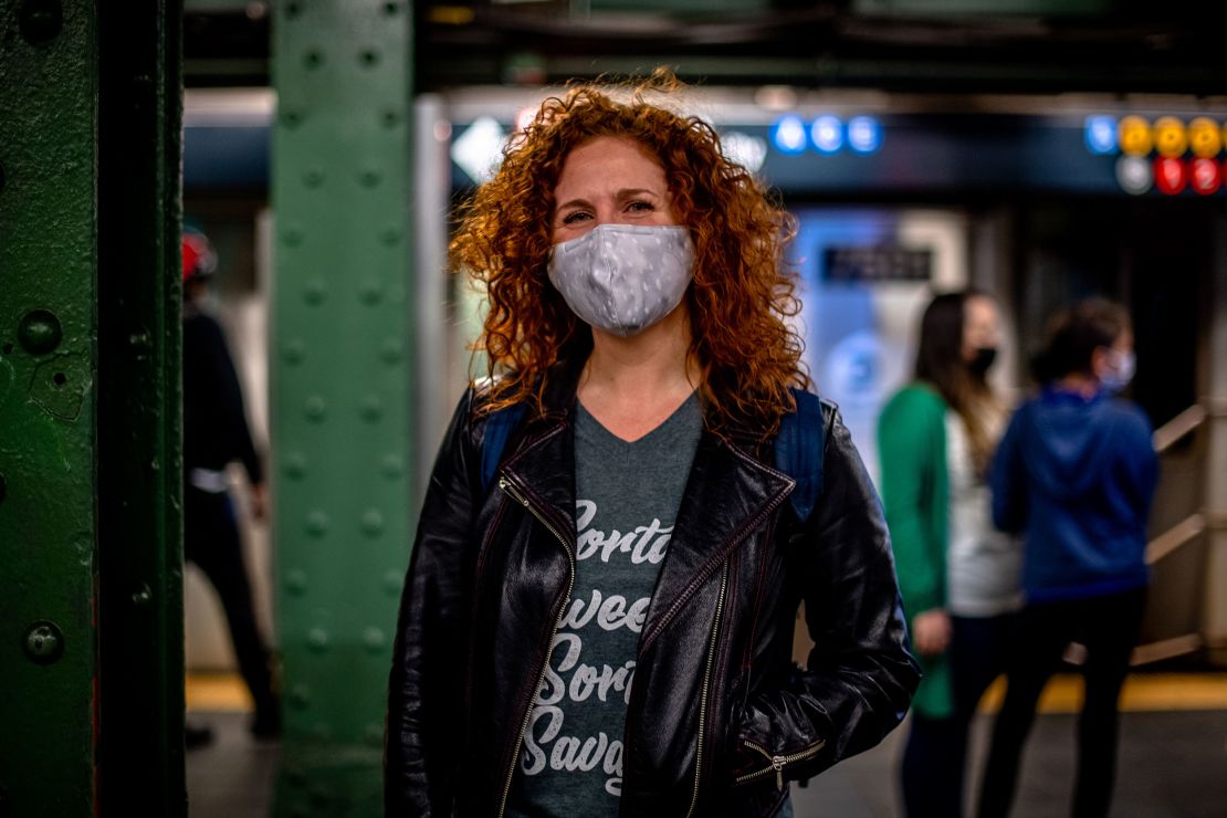 Dana Aber stands at a Times Square-42 Street subway platform.