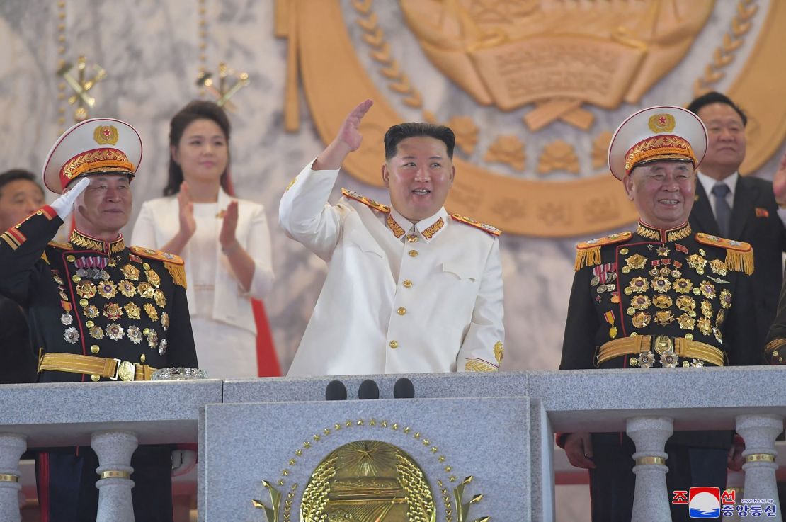 This picture taken on Monday and released from North Korea's official Korean Central News Agency on Tuesday shows North Korean leader Kim Jong Un, center, attending a grand military parade in Pyongyang.