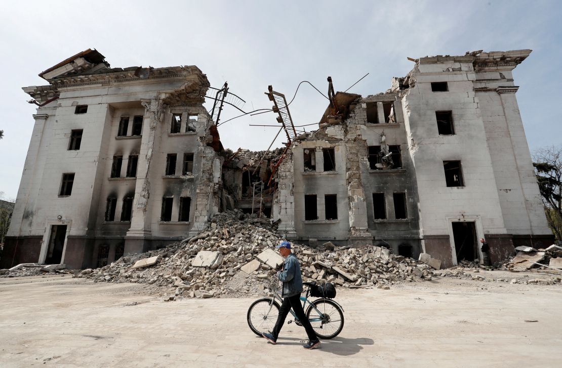 A man walks past the shell of Mariupol's Drama Theater on April 25.