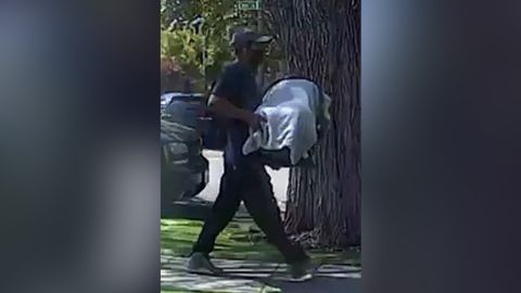 Police released images of a man carrying a covered car seat.