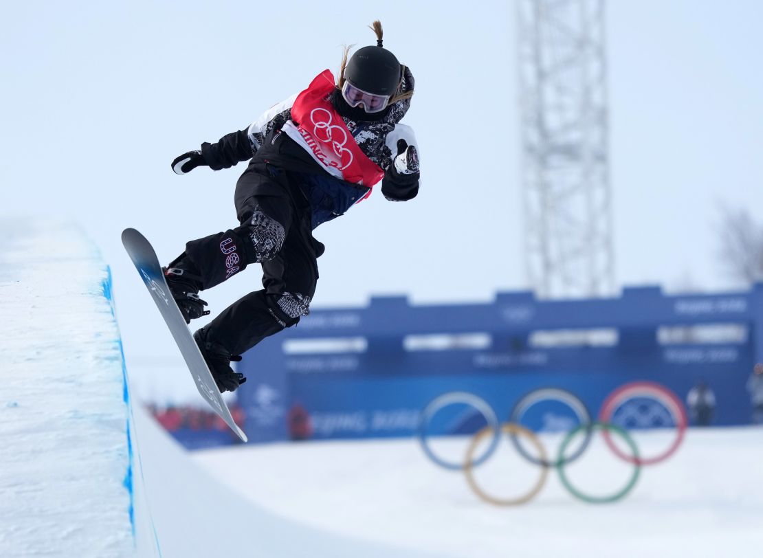 Chloe Kim performing a trick during the Women's Snowboard Halfpipe Final at the Beijing 2022 Winter Olympics.