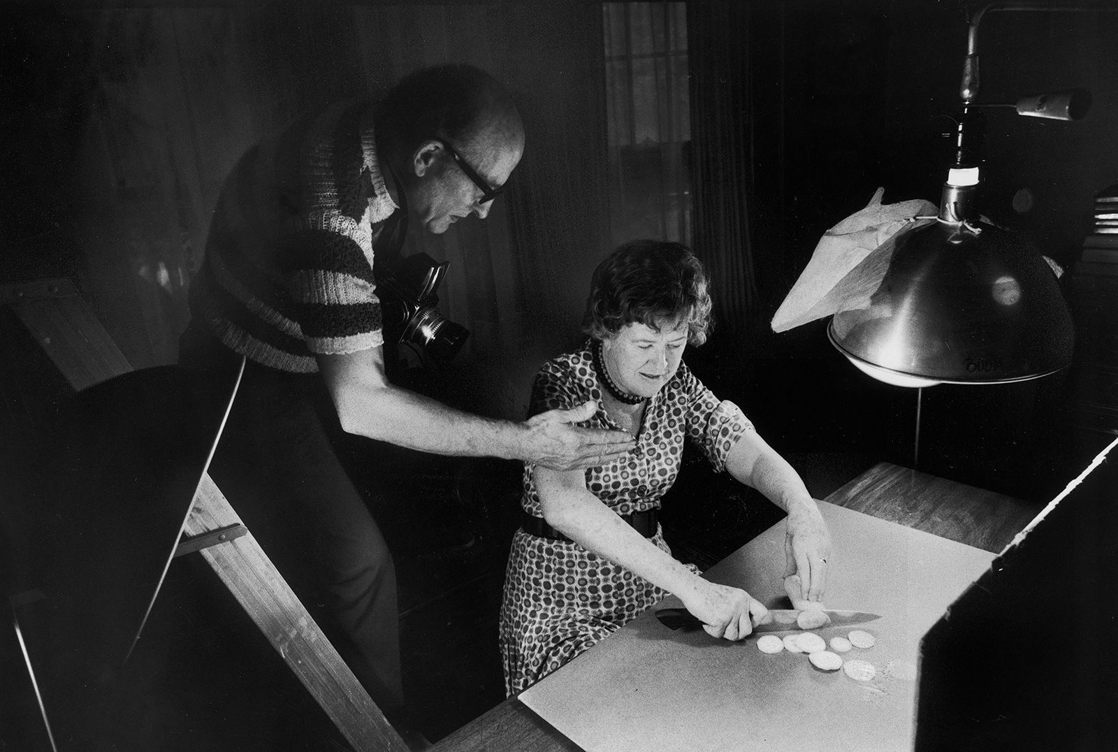 Child chops squash as her husband, Paul, photographs her for a cookbook in 1975. Paul was an avid photographer and painstakingly documented their lives in photos.