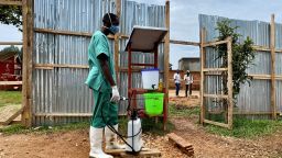 This file photo taken on March 21, 2021 shows a medical worker disinfecting a local Ebola treatment center in North Kivu province, northeastern Democratic Republic of the Congo DRC. )