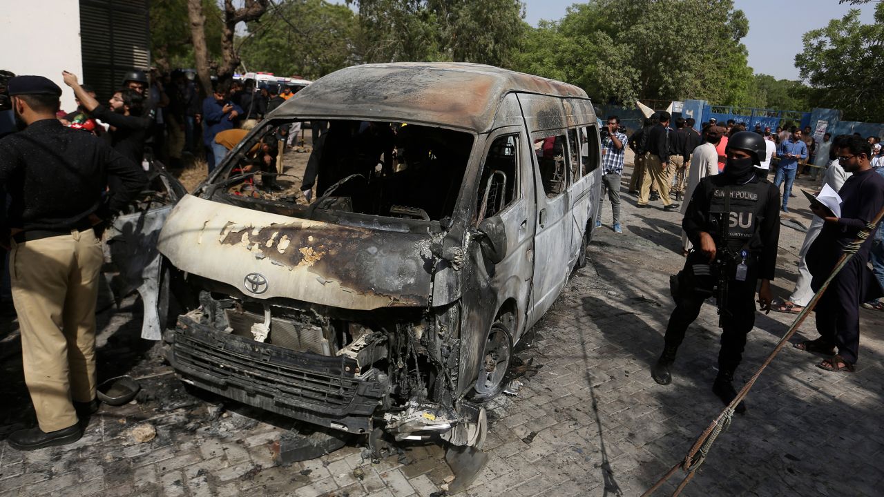 Pakistani investigators examine the site of the explosion in Karachi, Pakistan, on April 26. The explosion ripped through a van at a university campus in southern Pakistan on Tuesday, killing four people.