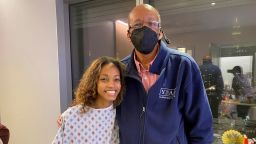 Eryn in the hospital with her dad, Alfred, after the transplant surgery.
