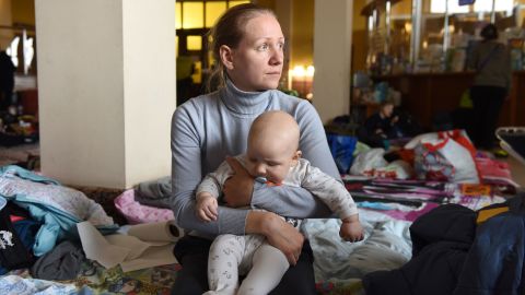 Ksenia, a 32-year-old from Kyiv, cradles her 6-month-old son Oleksandr. 