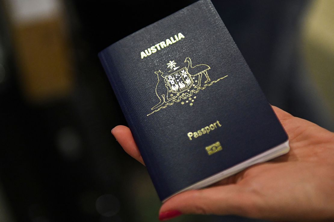 A traveler displays an Australian passport checking in for a flight to Sydney from Los Angeles International Airport.