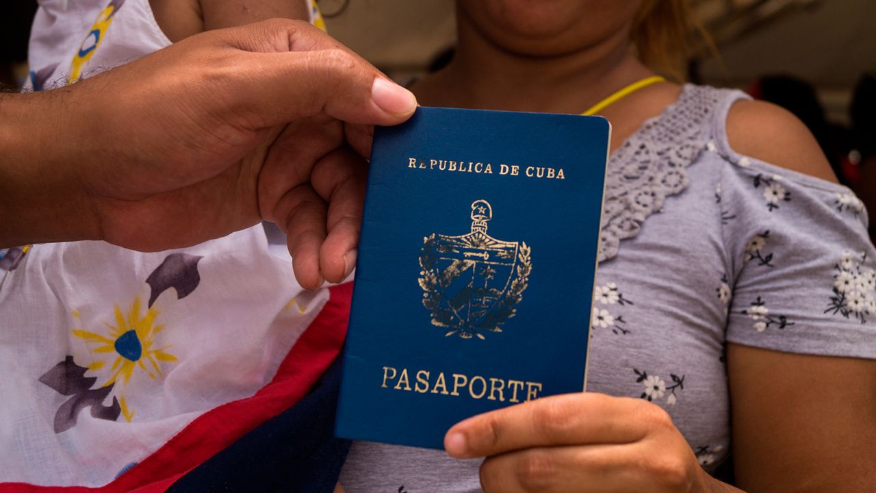 A Cuban migrant shows her Cuban passport  in Colombia.