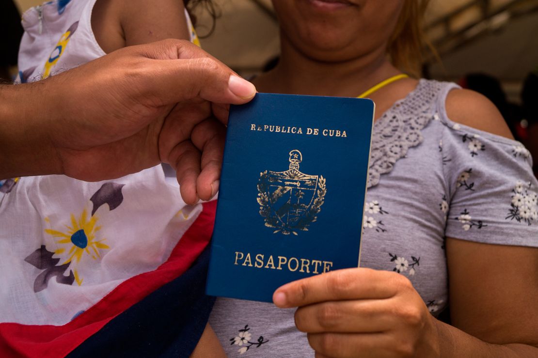 A Cuban migrant shows her Cuban passport  in Colombia.