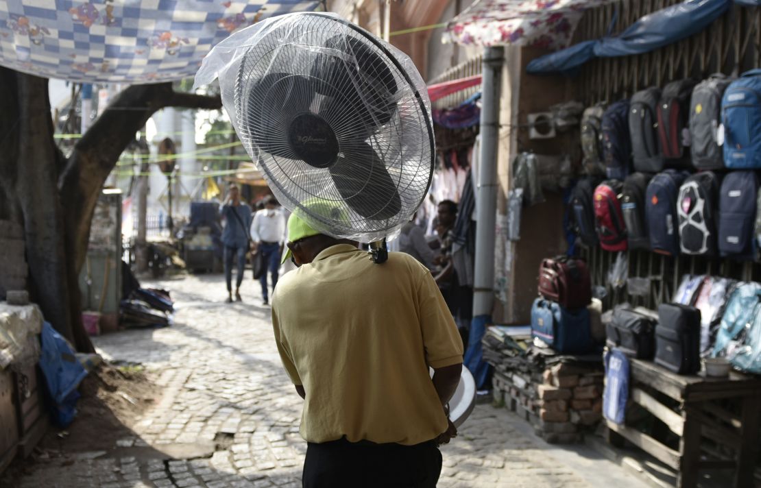 A man carries a fan during a heat wave in Kolkata, India.