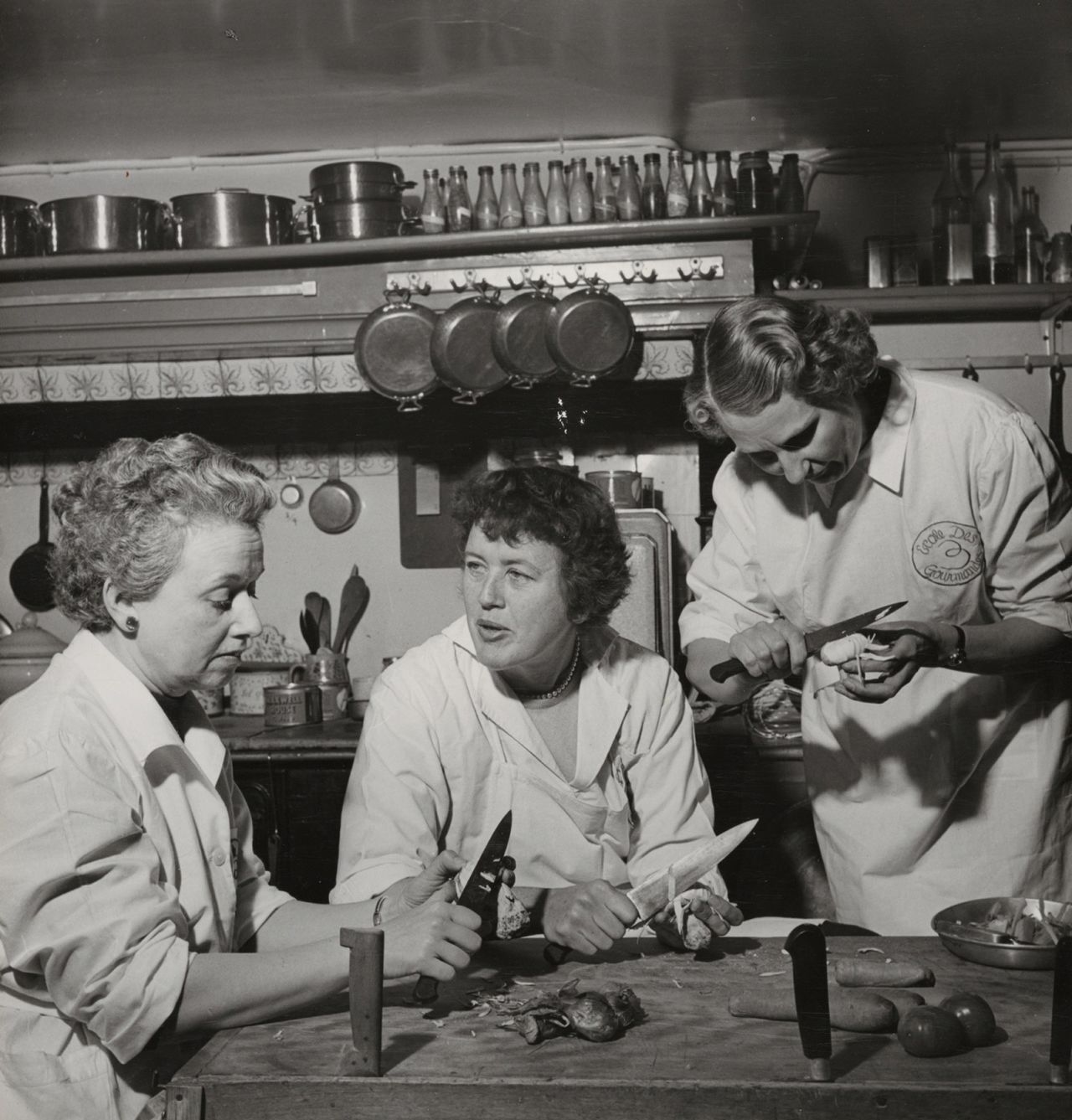 From left, Simone Beck, Child, and Louisette Bertholle peel vegetables at Ecole Des Trois Gourmandes, the cooking school they founded in Paris. The trio co-authored "Mastering the Art of French Cooking," the cookbook that launched Child's career in 1961.