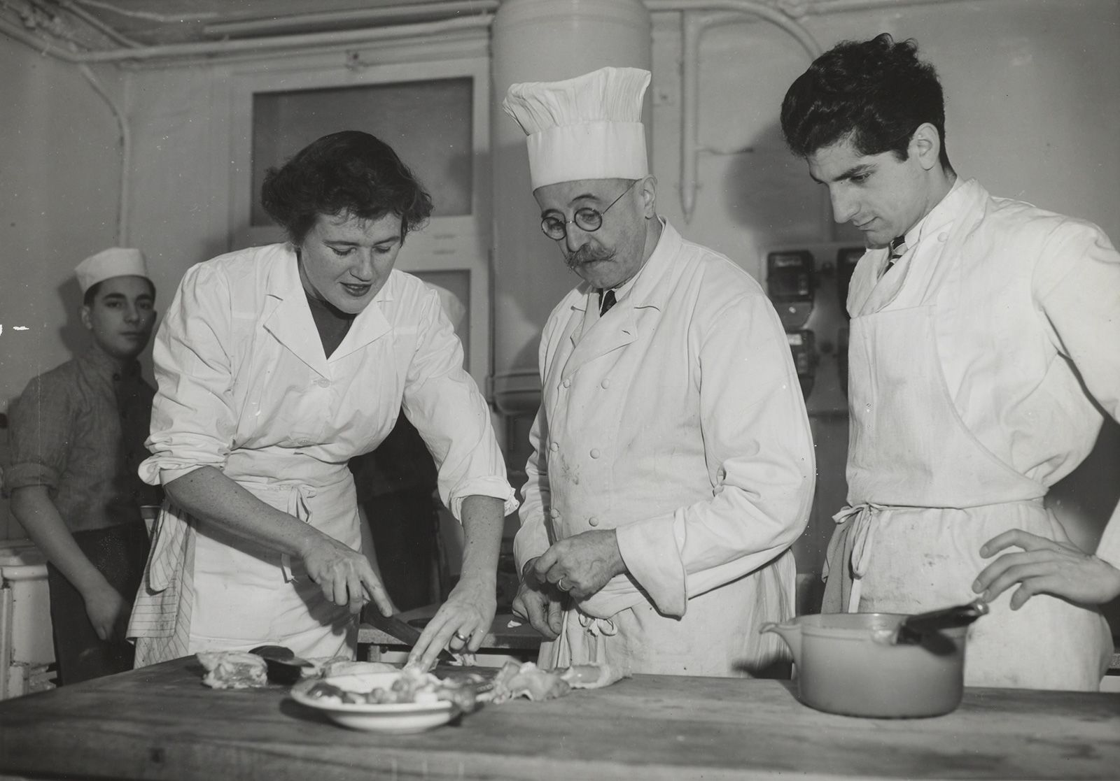 Child with other chefs and students at the Le Cordon Bleu cooking school in Paris in 1950. Child has said her first meal in France inspired her exploration of cooking and food.