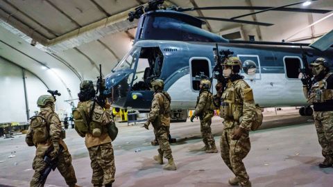 Taliban fighters, wielding American supplied weapons, equipment and uniforms, storm into the Kabul International Airport to secure the airport and inspect the equipment that was left behind after the US military completed their withdrawal, Tuesday, Aug. 31, 2021.