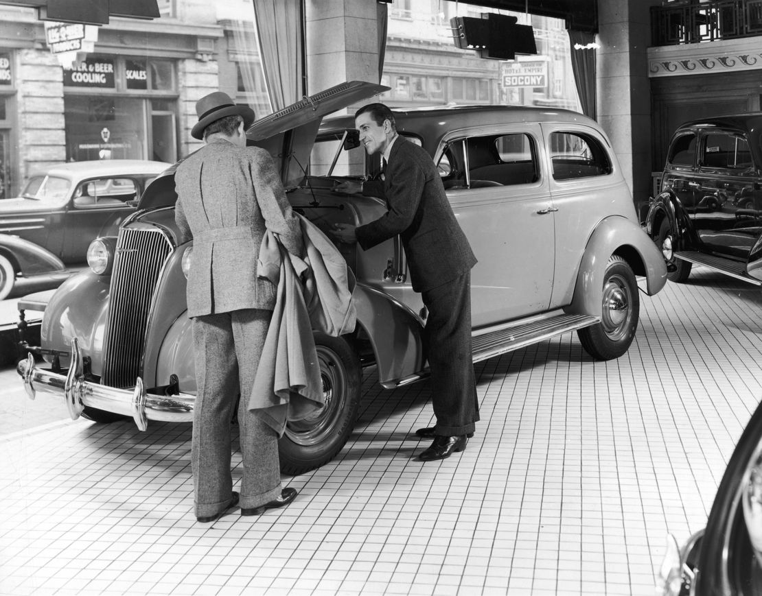 By the mid-20th century, car dealers had real political influence and helped pass laws that protected their independent businesses from encroachment by big automakers. Here, a salesman shows off the engine of a 1937 Chevrolet Master.