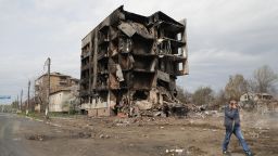 A man talking on the phone walks past the ruins of an apartment block destroyed as a result of Russian shelling in Borodianka, an urban-type settlement liberated from Russian invaders, Kyiv Region, northern Ukraine, on April 25, 2022. Photo by Yuliia Ovsiannikova/Ukrinform/Abaca/Sipa USA