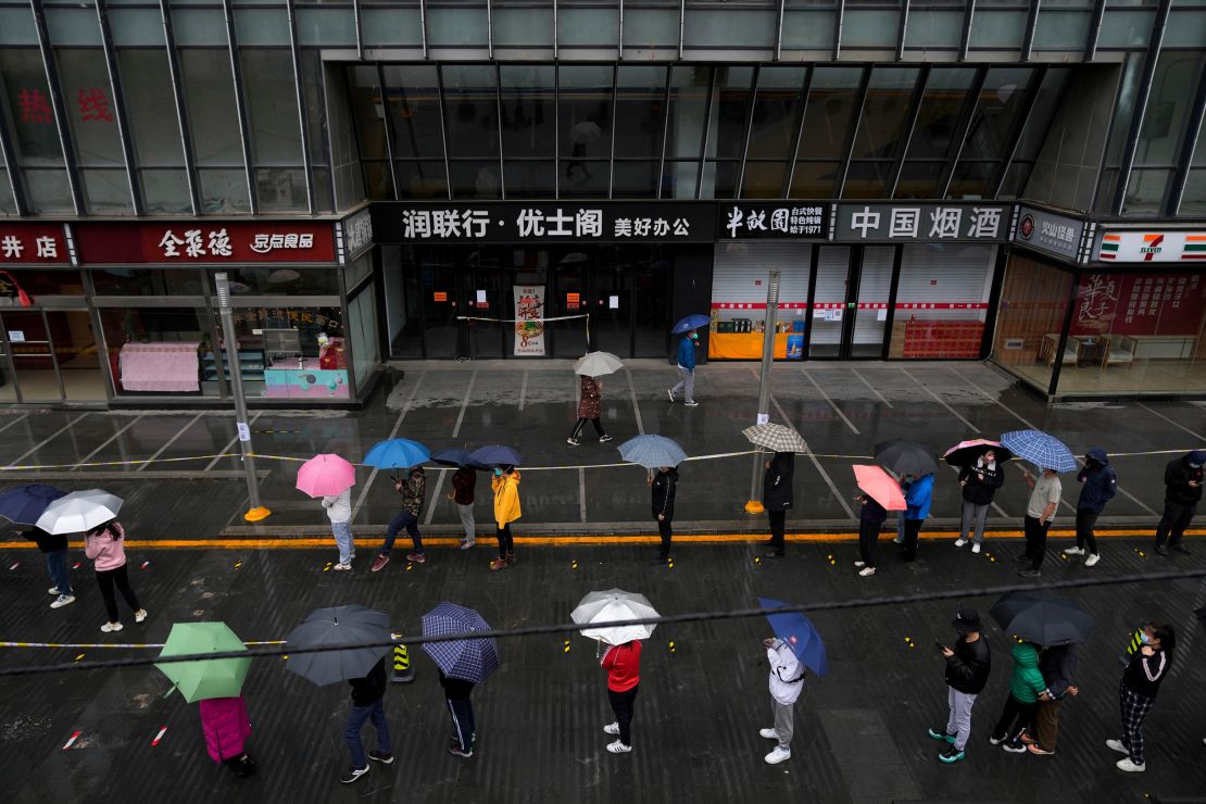 Locked-down residents line up in the rain for Covid tests in Beijing on April 27.