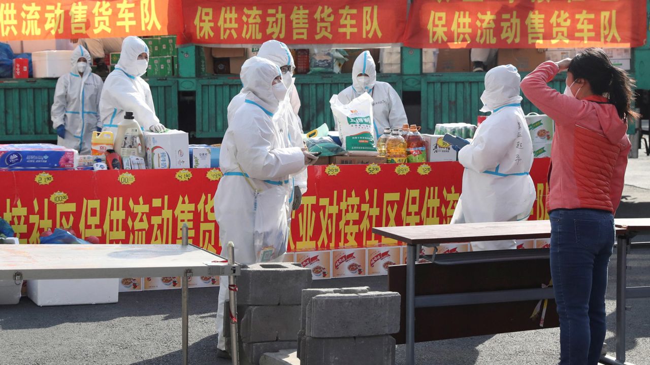 Health workers stand inside a residential compound in Changchun, China, on April 19.