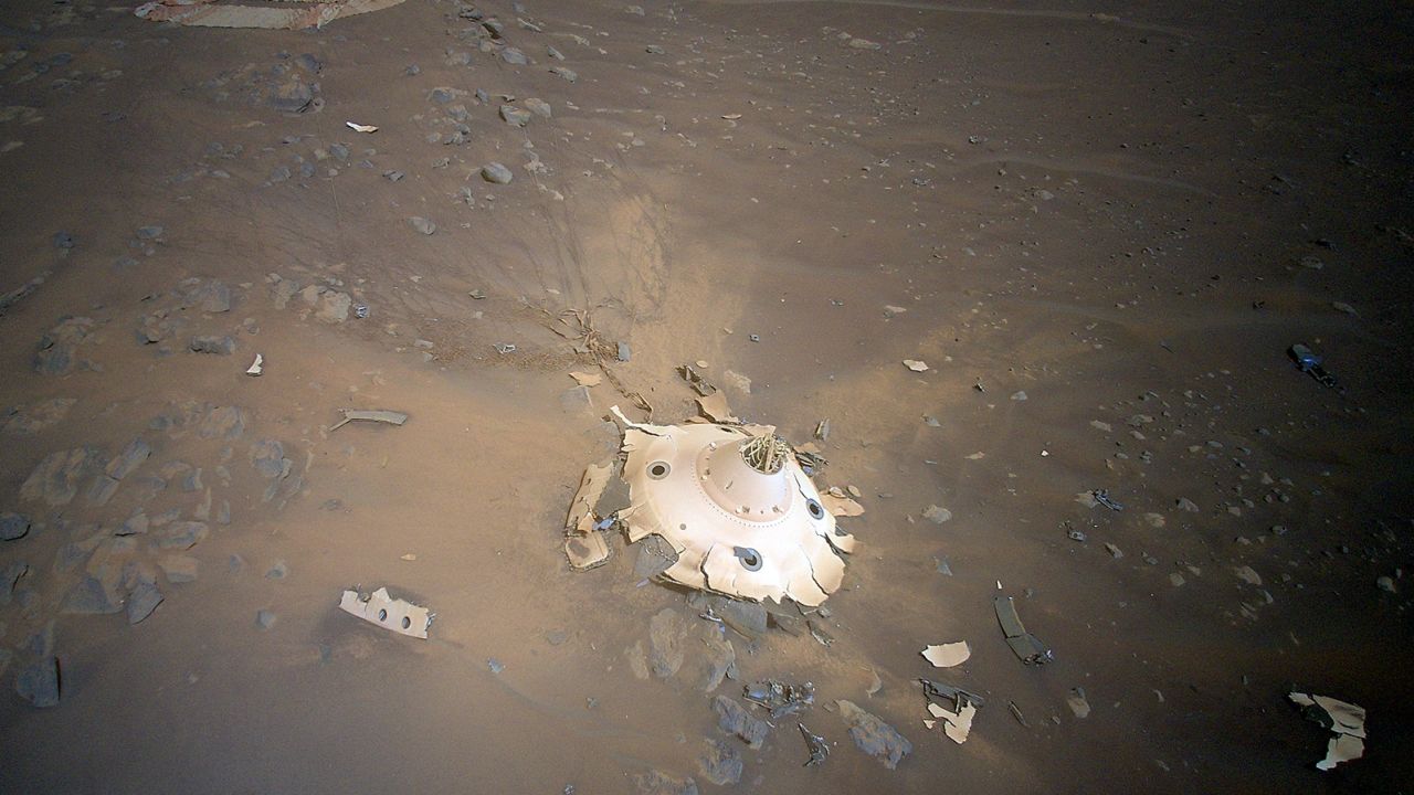 Cables attaching the backshell (center) to the parachute (top left) appear to still be intact.