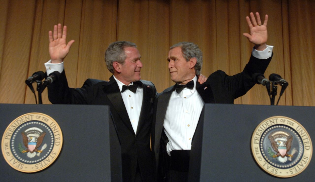 US President George W. Bush, left, waves with impressionist Steve Bridges at the White House Correspondents' Dinner in 2006.