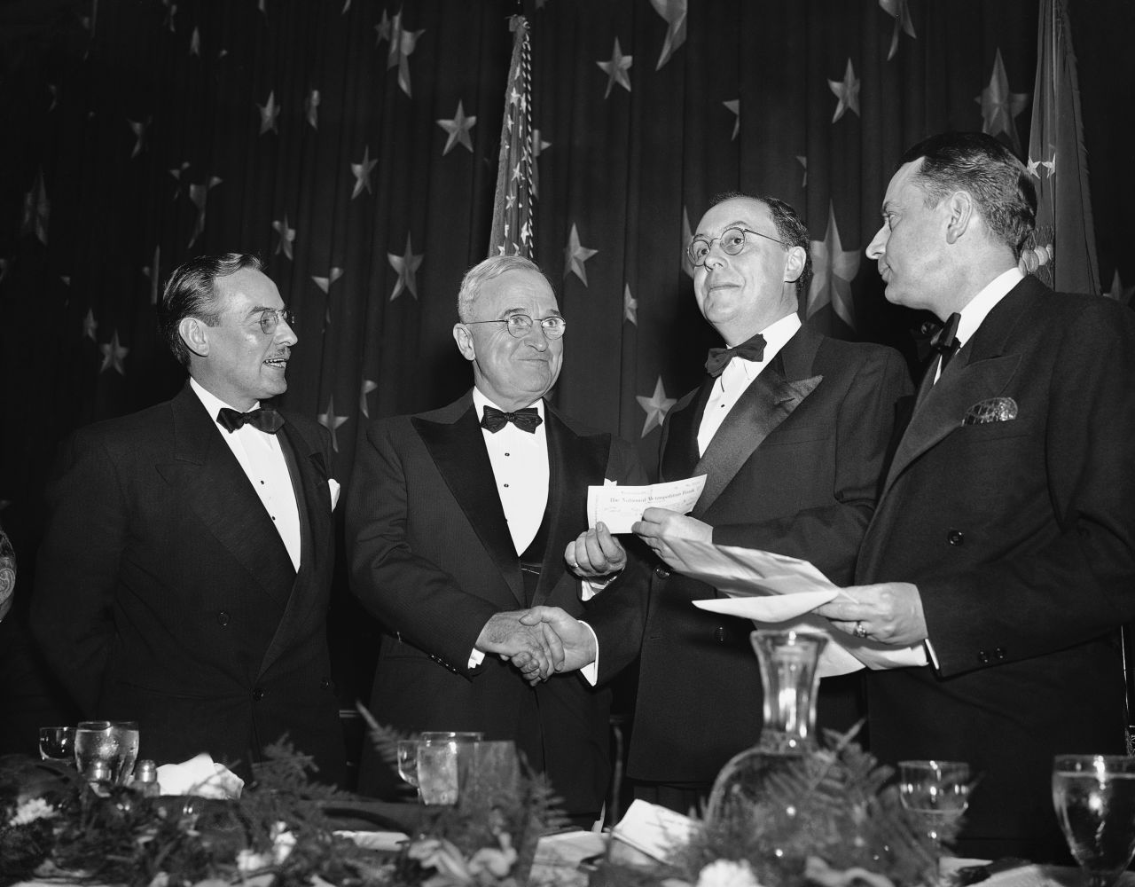 President Harry Truman, second from left, presents a $500 check to Peter Edson, second from right, for winning the Raymond Clapper Memorial Award in 1949.