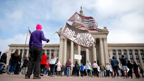 A person holds flags during the Bans Off Oklahoma Rally on the steps on Oklahoma state Capitol in Oklahoma City on Tuesday, April 5, 2022.