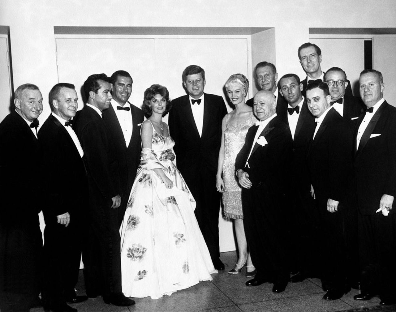Until 1962, the correspondents' dinner was open to just men. President John F. Kennedy, center, refused to attend until it was opened to women.