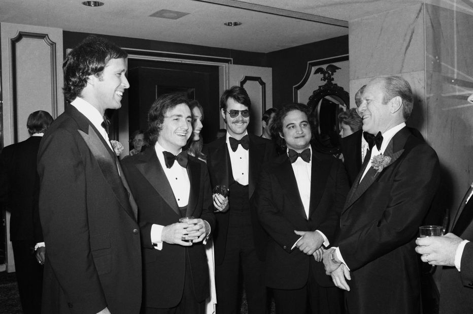 President Gerald Ford, right, speaks with comedian Chevy Chase, left, in 1976. Chase famously portrayed Ford as clumsy on "Saturday Night Live." Between the two, from left, are "Saturday Night Live" creator Lorne Michaels and cast members Dan Aykroyd and  John Belushi.
