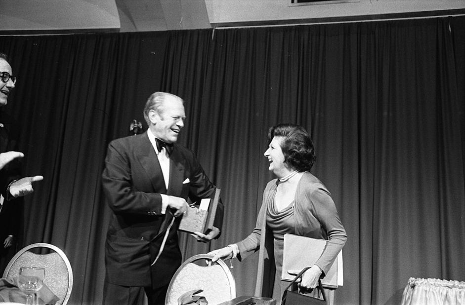 Ford laughs with Helen Thomas, a White House correspondent with United Press International, at the 1975 dinner. Thomas was the first female president of the White House Correspondents' Association.