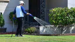 A man waters his lawn in Alhambra, California on April 27, 2022, a day after Southern California delared a water shortage emergency, with unprecedented new restrictions on outdoor watering for millions of people living in Los Angeles, San Bernardino and Ventura counties. - Southern California's Metropolitan water district will allow for outdoor watering tp just one day per week effective June 1st. (Photo by Frederic J. BROWN / AFP) (Photo by FREDERIC J. BROWN/AFP via Getty Images)