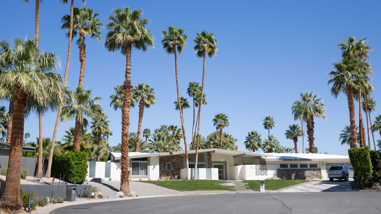 A home in the historic Las Palmas neighborhood in Palm Springs, with a combination of grass and xeriscaping in the front yard. 