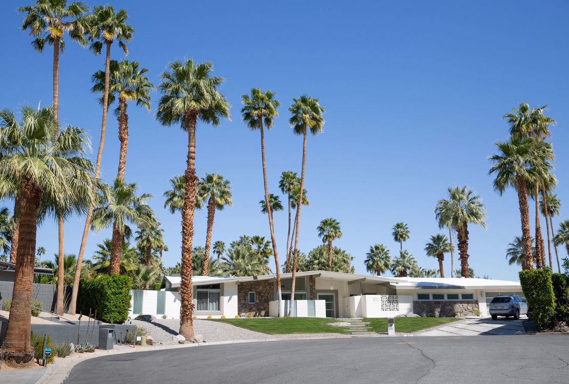 A home in the historic Las Palmas neighborhood in Palm Springs, with a combination of grass and xeriscaping in the front yard. 