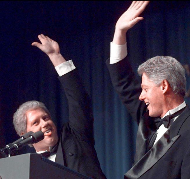 Clinton high-fives a "clone" of him played by actor Darrell Hammond in 1997.