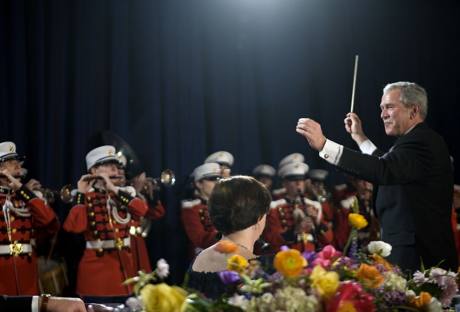 President George W. Bush conducts the Marine Corps Band during the dinner in 2008.