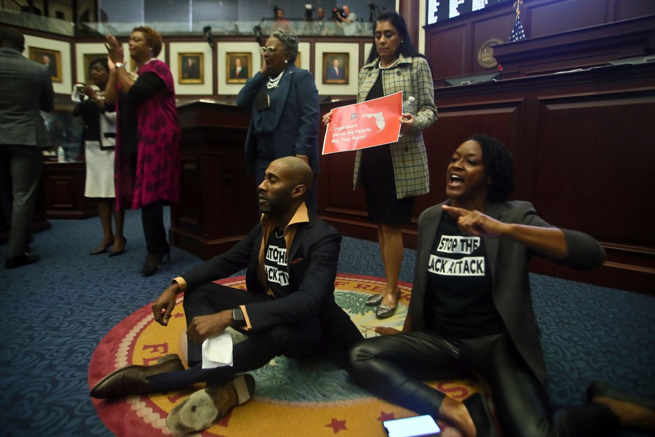 Florida Reps. Tray McCurdy and Angie Nixon sit on the floor of the Florida House on Thursday, April 21, as they <a href="https://www.cnn.com/2022/04/21/politics/florida-congressional-map/index.html" target="_blank">protested a new congressional map</a> that would eliminate two state districts represented by Black Democrats. The protest forced an informal recess before Republicans returned and voted to send the map to the desk of Gov. Ron DeSantis.