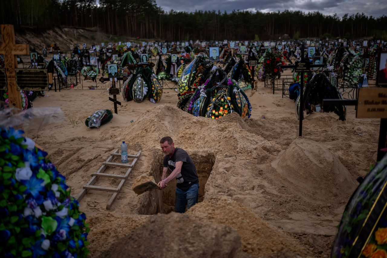 A man digs a grave at a cemetery in Irpin, Ukraine, on the outskirts of Kyiv, on Wednesday, April 27.