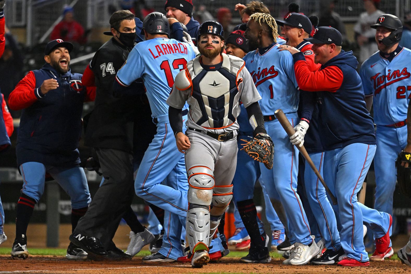 Detroit catcher Eric Haase walks off the field as the Minnesota Twins celebrate a walk-off win at a Major League Baseball game in Minneapolis on Tuesday, April 26. Haase's throwing error capped off a <a href="index.php?page=&url=https%3A%2F%2Fwww.freep.com%2Fstory%2Fsports%2Fmlb%2Ftigers%2F2022%2F04%2F26%2Fdetroit-tigers-game-recap-minnesota-twins-javier-baez%2F9547063002%2F" target="_blank" target="_blank">bizarre play</a> that gave the Twins the victory.