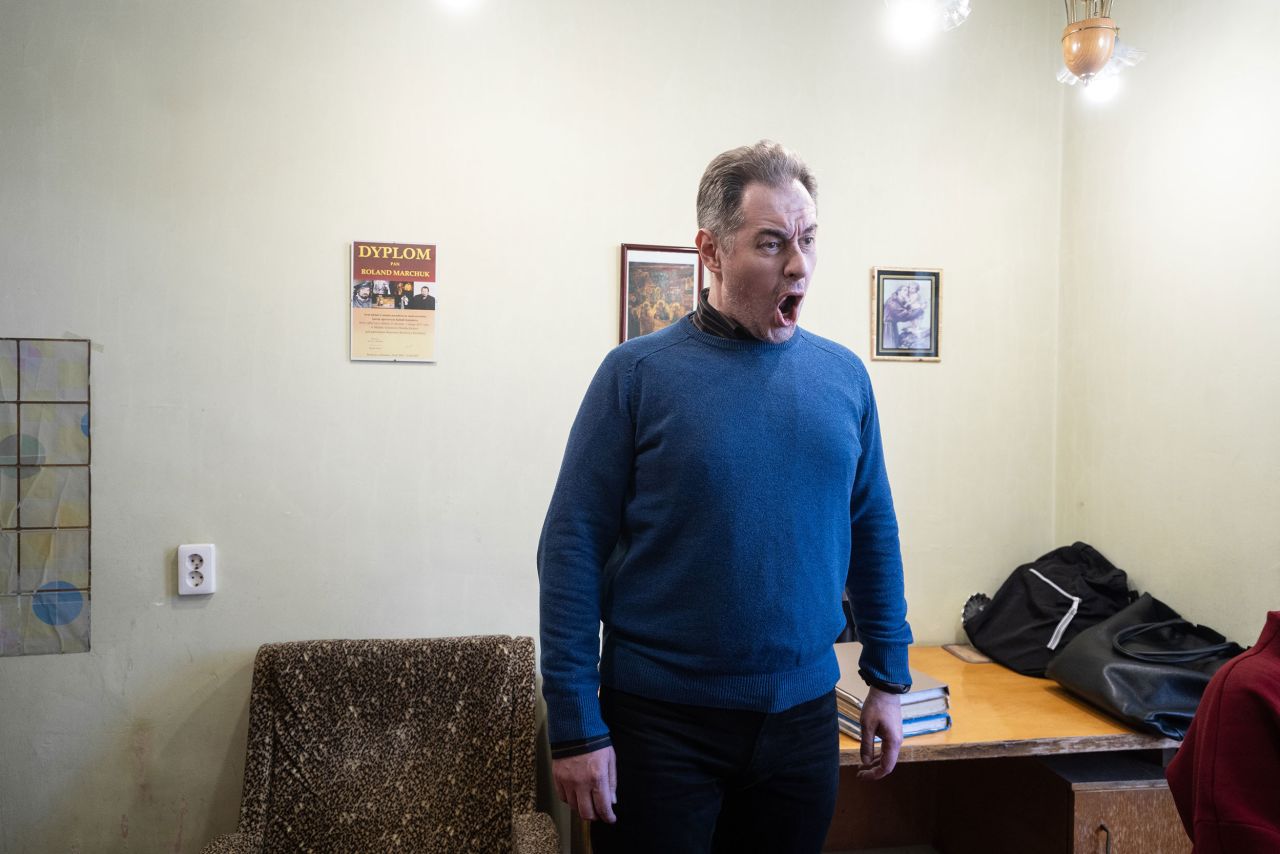 Opera singer Roland Marchuk trains in his office.