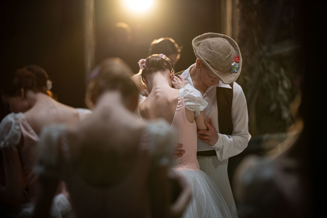 Two dancers embrace as part of the performance.