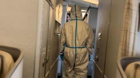 Flight attendants wear hazmat suits on a China Eastern Airlines flight from Tokyo to Kunming, China.