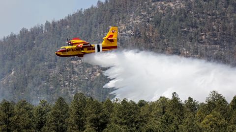 In this photo released by the U.S. Forest Service, an aircraft known as a "super scooper" battles the Hermits Peak and Calf Canyon Fires in the Santa Fe National Forest in New Mexico on Thursday, April 28, 2022.