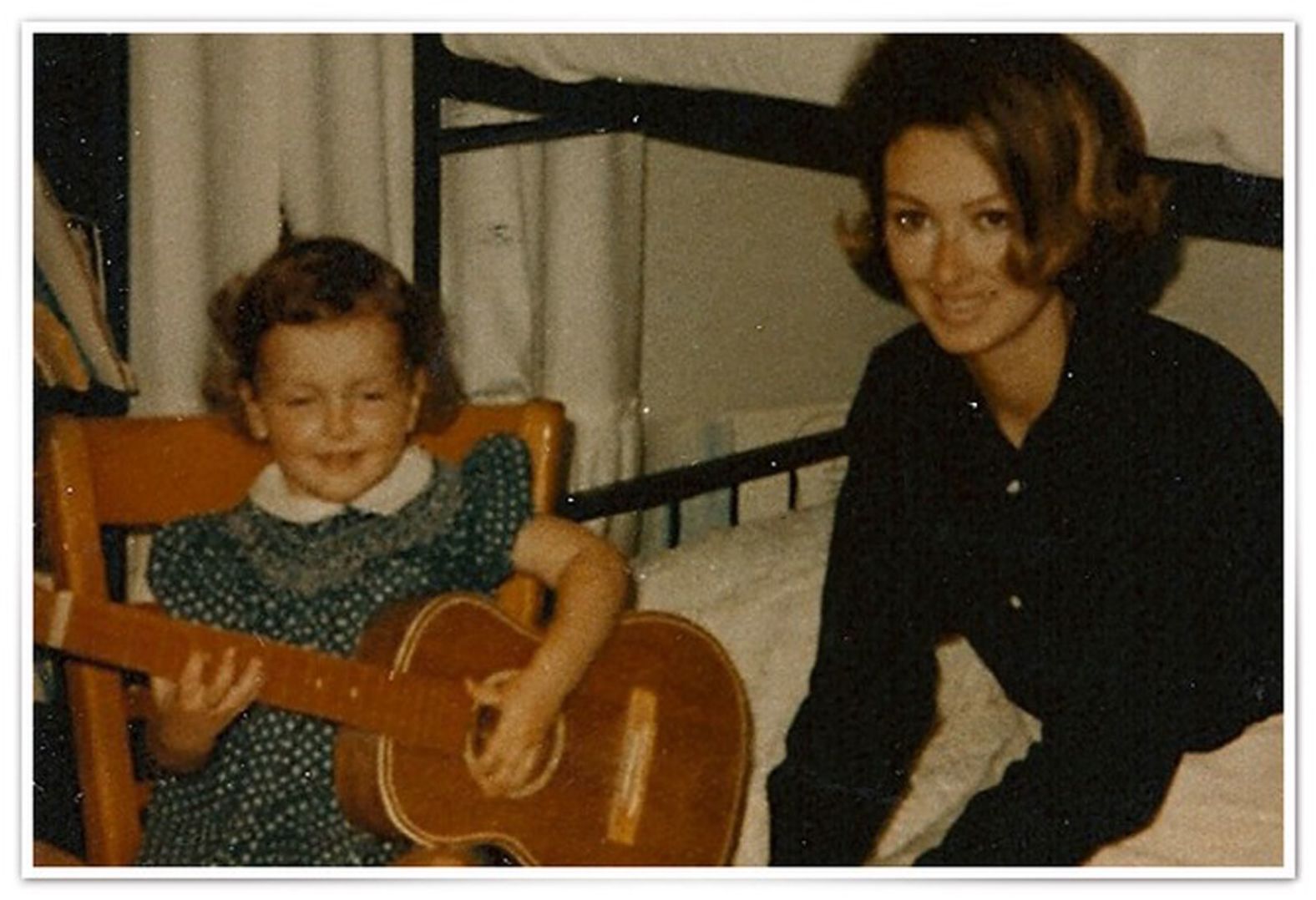 Wynonna Judd, left, shows off her first toy guitar in 1970.