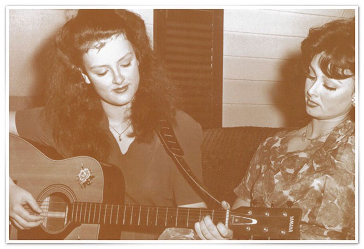 By 1980, Judd had started pursuing a musical career for her and her daughter. The two sing together on a porch while Wynonna plays guitar.