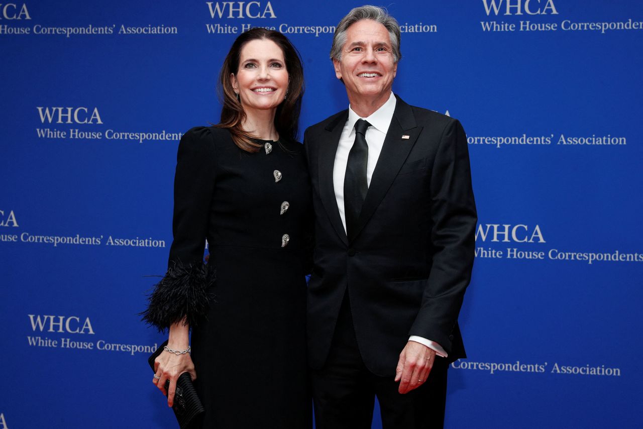 US Secretary of State Antony Blinken and his wife Evan Ryan pose for photos on the red carpet.