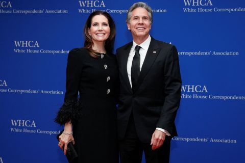 US Secretary of State Antony Blinken and his wife Evan Ryan pose for pictures on the red carpet.