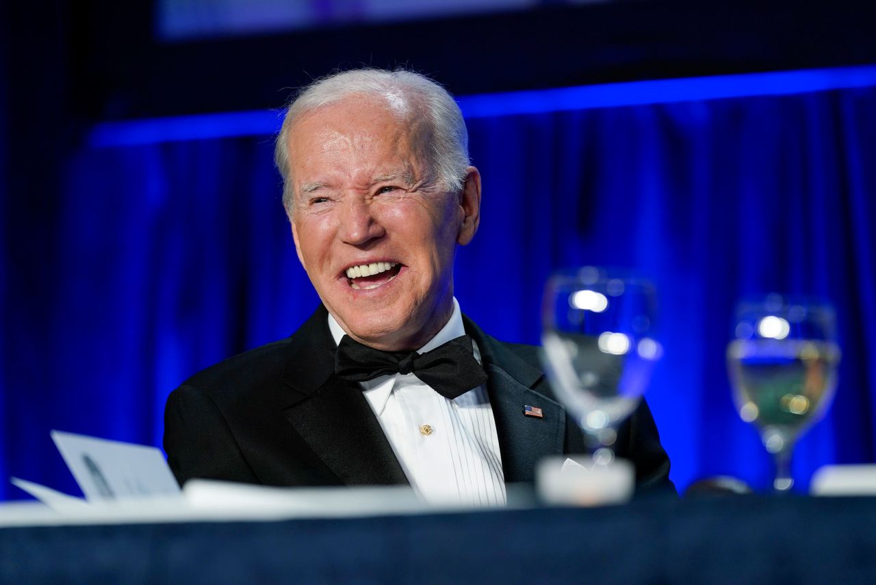 President Joe Biden laughs as he listens to Trevor Noah speak at Saturday's dinner.