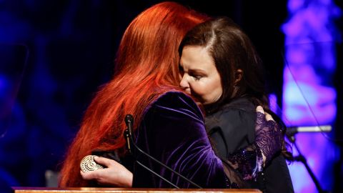Ashley Judd (right) hugs her sister Wynonna at the induction ceremony on Sunday.