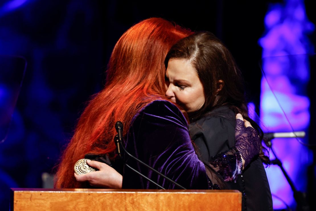 Ashley Judd (right) hugs her sister Wynonna at the induction ceremony on Sunday.