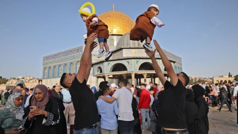 Muslims play with their children in front of the Dome of the Rock after the morning Eid al-Fitr prayer, which marks the end of the holy fasting month of Ramadan, at the Al-Aqsa mosque compound in Jerusalem's Old City early on May 2.